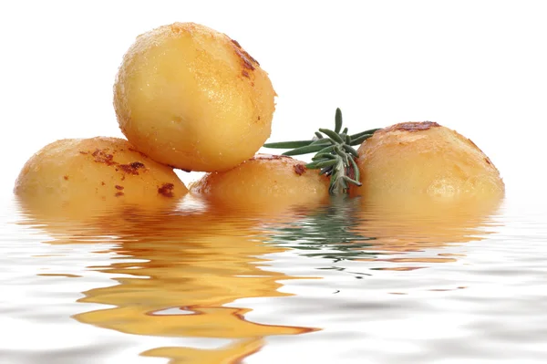 Roast potatoes with rosemary on a water bed — Stock Photo, Image