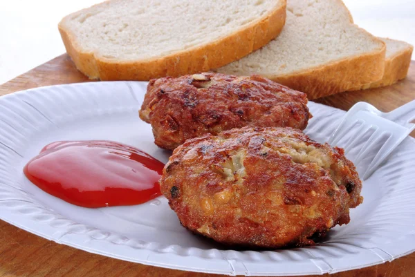 Burgers with ketchup on a white paper plate — Stock Photo, Image
