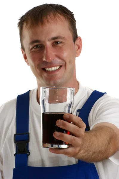 Craftsmen in blue overall holding a soft drink — Stock Photo, Image