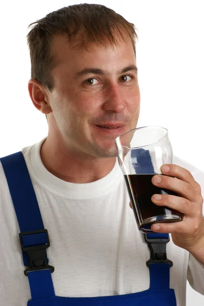 Craftsmen in blue overall holding a soft drink — Stock Photo, Image