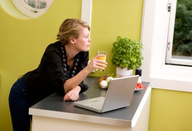 In Kitchen with Laptop clipart