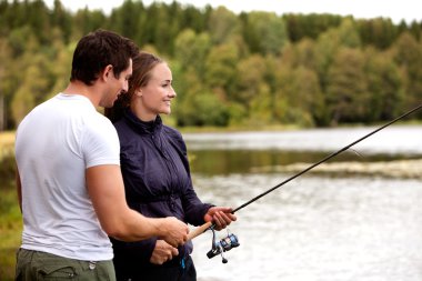 Man and Woman Fishing clipart