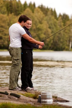 Man and Woman Fishing clipart