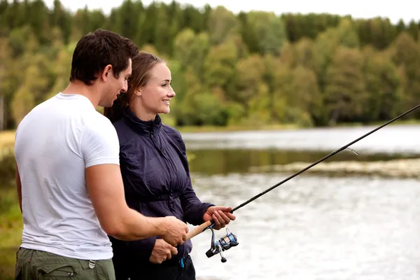 Man och kvinna fiske — Stockfoto