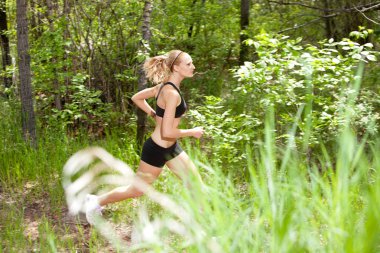 Woman running in the forest clipart