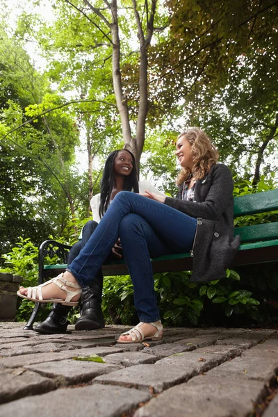 Unga kvinnor prata med varandra i park — Stockfoto