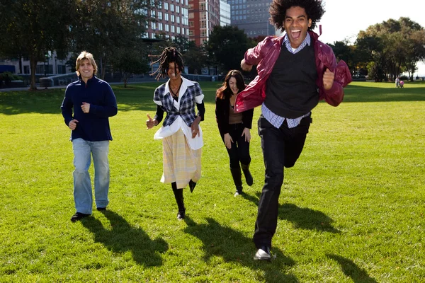 Four Running Through an Urban Park — Stock Photo, Image
