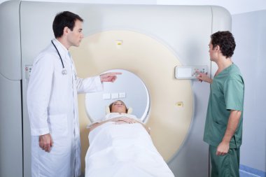 Patient going through an MRI scan clipart