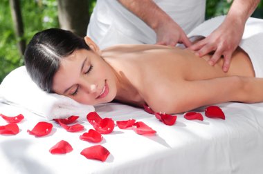 Young woman getting a back massage clipart