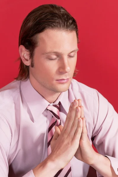 Closeup of a businessman in prayer posture — Stock Photo, Image