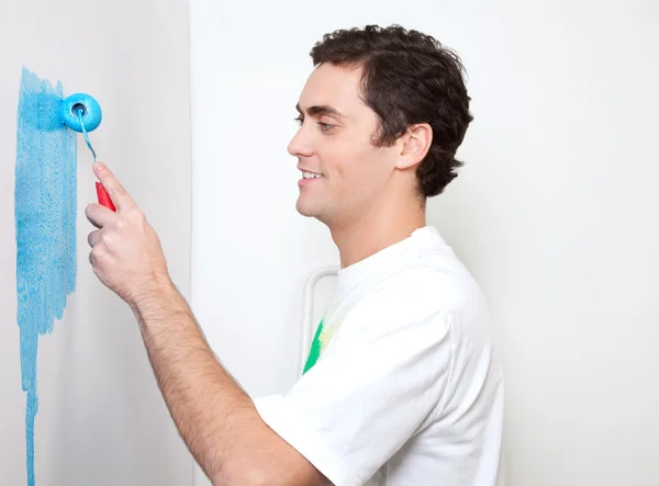 Happy young man applying color — Stock Photo, Image