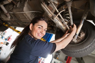 Portrait of smiling young female mechanic clipart