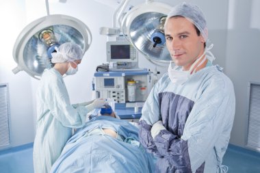 Confident surgeon in operating room clipart