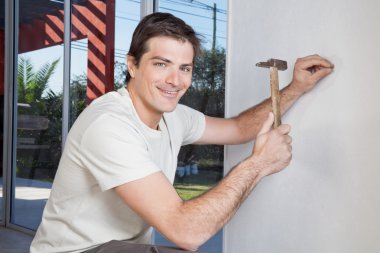 Man hammering the wall clipart