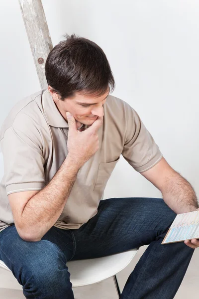 Man looking at color guide — Stock Photo, Image