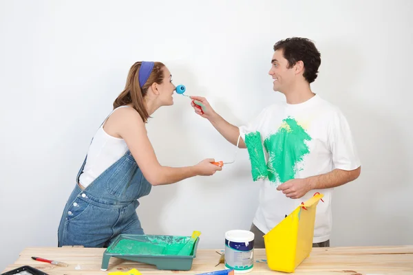 Playful couple playing with paint — Stock Photo, Image