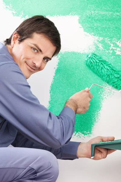 Handsome man painting house — Stock Photo, Image
