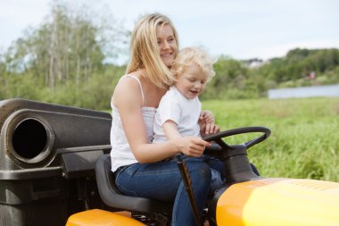 Mother and Child mowing grass clipart