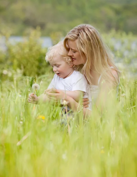 Mother and Son with Dandelion in Meadow — Stock Photo, Image