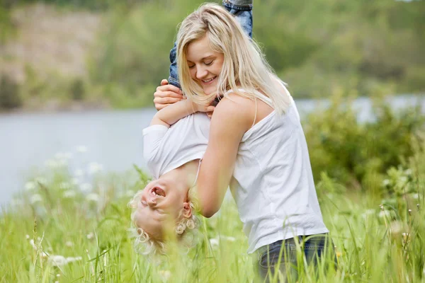 Pretty woman playing with her son — Stock Photo, Image