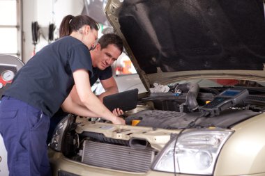 Mechanic using Digital Tablet clipart