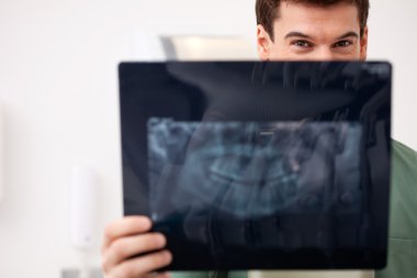 Young Male Dentist with X-ray clipart