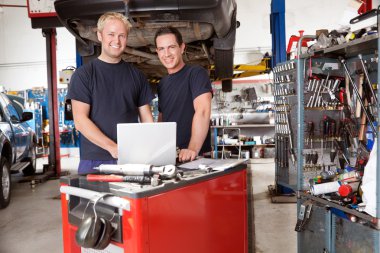 Portrait of smiling mechanics clipart