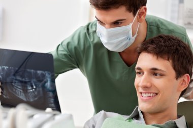 Patient looking at his tooth x-ray clipart