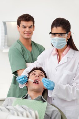 Patient having dental check up clipart