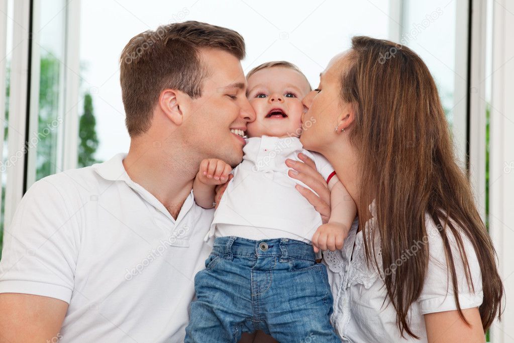 Parents kissing child — Stock Photo © SimpleFoto #6621688