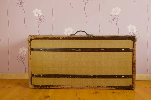 Suitcase on wooden floor — Stock Photo, Image