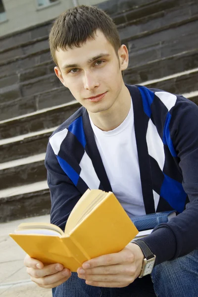 Чоловік студент в кампусі з підручниками — стокове фото