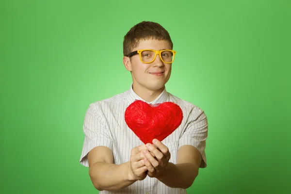 Smiling guy holding heart shape — Stock Photo, Image
