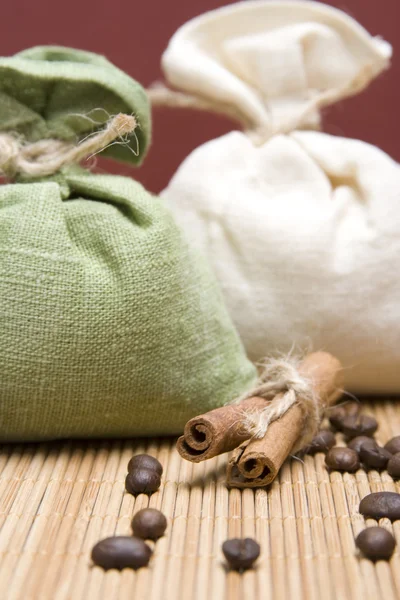 Close-up of two bags of coffee and cinnamon — Stock Photo, Image