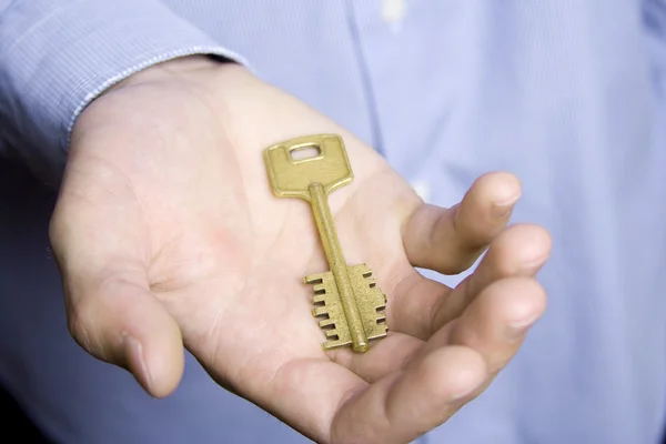 Close-up of key on the palm of a man