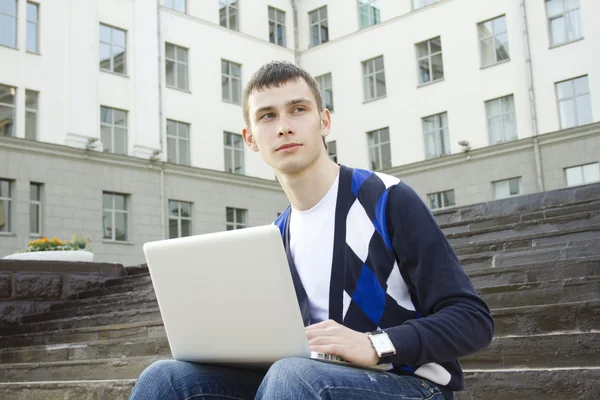 Jovem estudante trabalhando em um laptop — Fotografia de Stock