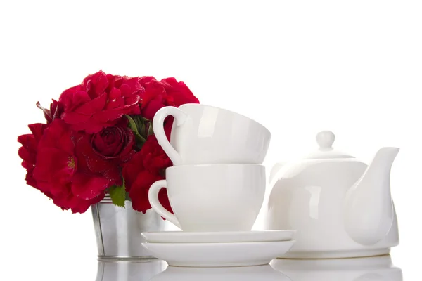 White crockery for tea and a bouquet of roses — Stock Photo, Image