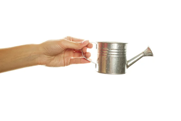 Woman hand with a steel watering can — Stock Photo, Image