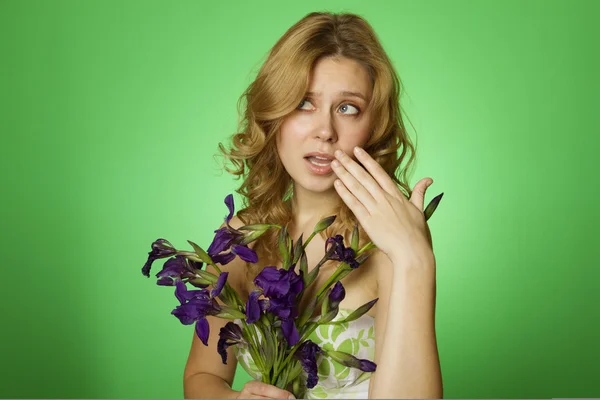 Attractive girl hugging a bouquet of Irises — Stock Photo, Image