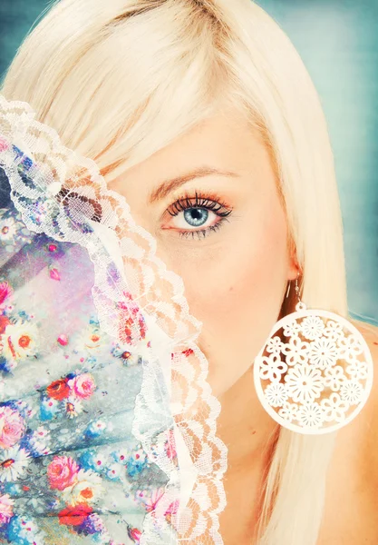 Beautiful blond woman with a delicate fan — Stock Photo, Image