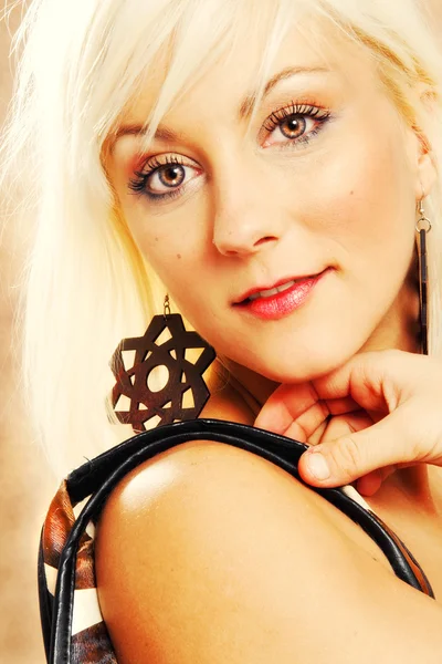 Close-up portrait of a young blond woman with earrings — Stock Photo, Image