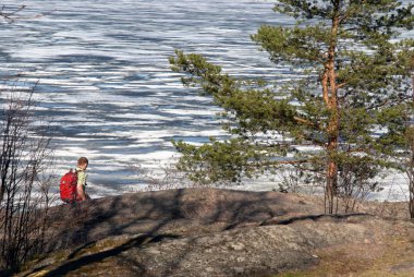 Tourist with a backpack on a background a lake