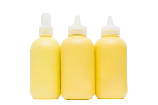 Κίτρινο καλλυντικό μπουκάλι που απομονώνονται σε λευκό — Φωτογραφία Αρχείου