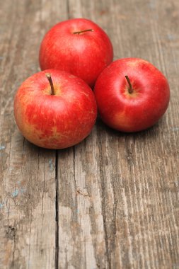 Red ripe apple on old wooden background clipart