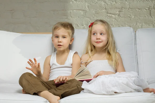 Sonriente niños gemelos leer un cuento —  Fotos de Stock