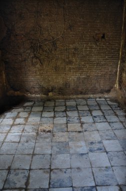 Dirty tiled floor and brick wall empty room clipart