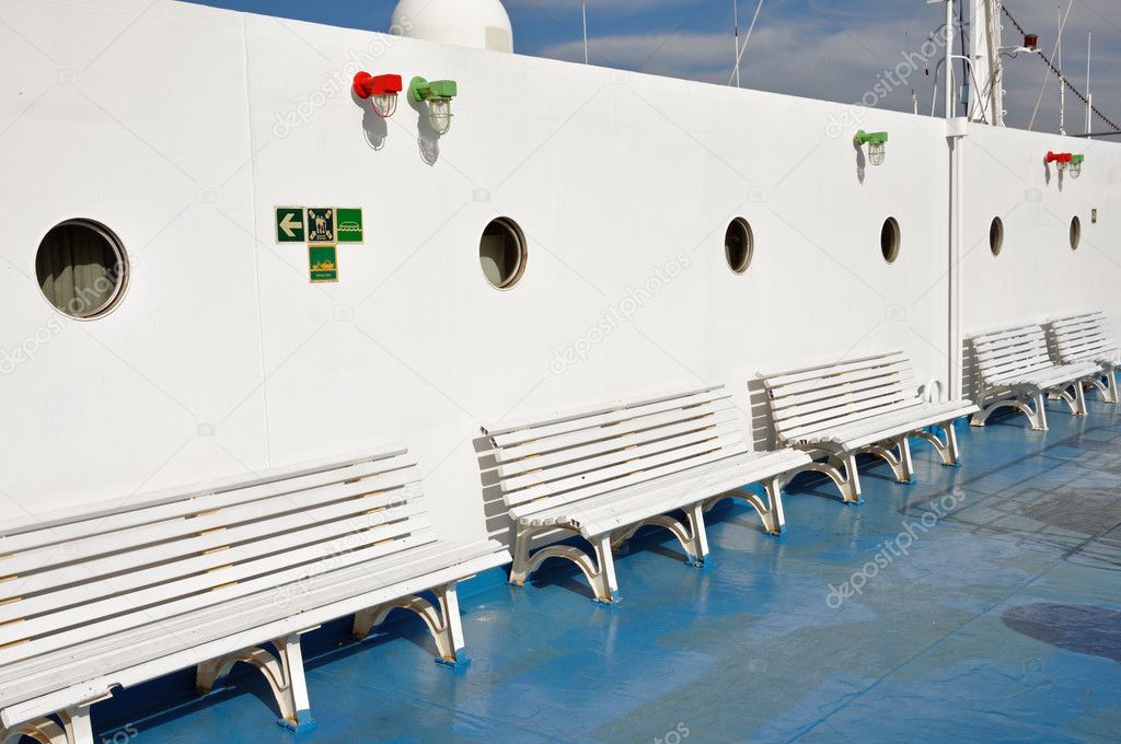 Benches and portholes on ship deck