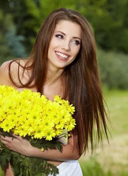 Jonge vrouw bedrijf gele bloemen — Stockfoto