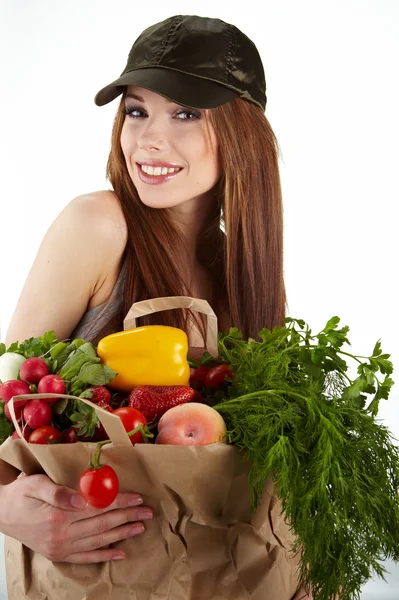 Portrait of happy woman holding a shopping bag full of groceries Stock Photo