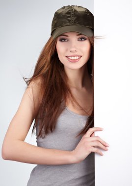 Beautiful woman holding empty white board